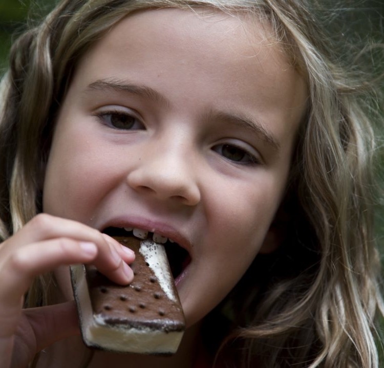 Girl Eating Ice Cream Bar, Lake Of The Woods, Ontario, Canada