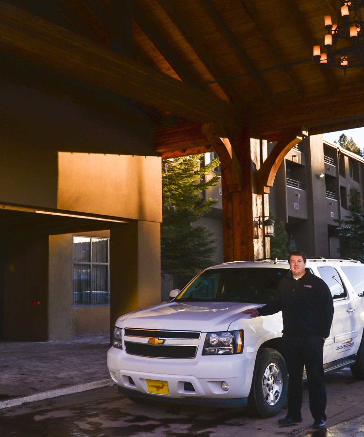 roadrunner shuttle suburban parked outside the angel fire resort lodge