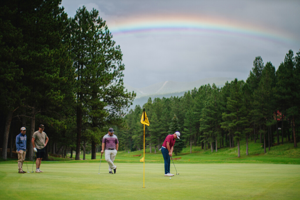 Hunter putting under a rainbow.